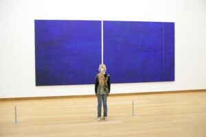 young girl in Stedelijk museum before painring Cathedra by Barnett Newman