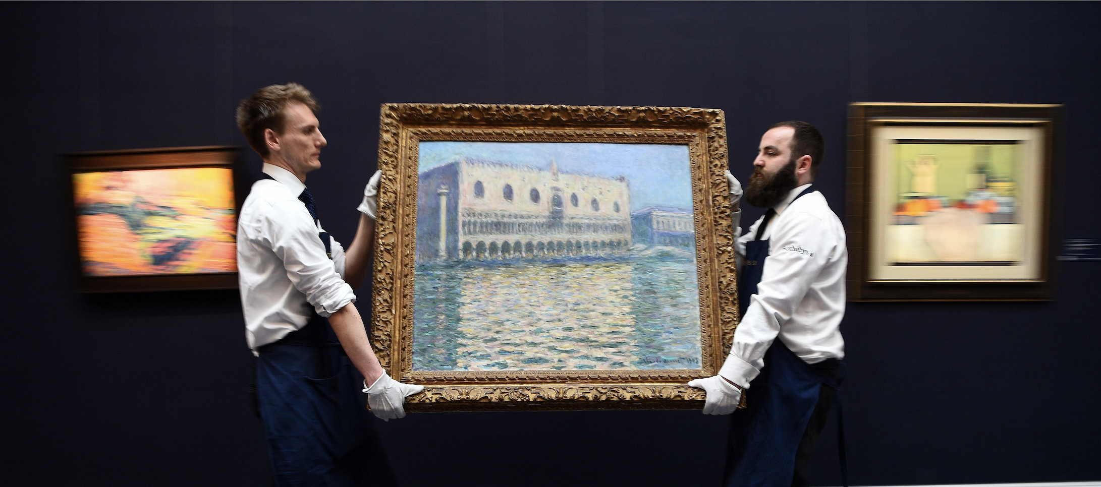 art handlers moving painting to auction. Courtesy of Alamy