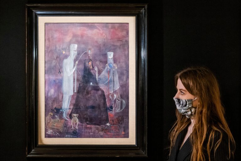 Woman observing Leonora Carrington Painting at preview of Bonhams' 2021 Century Week including at Bonhams New Bond Street. Guy Bell/Alamy Live News