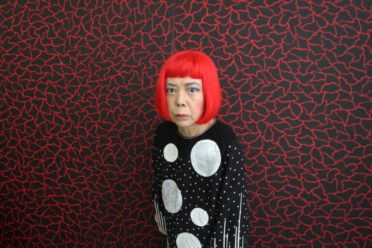 Japanese artist Yayoi Kusama, whose paintings are listed on the artwork pricing database of art investment platform Masterworks, stands in front of one of her paintings in her studio, Tokyo, Japan. Jeremy Sutton-Hibbert / Alamy Stock Photo