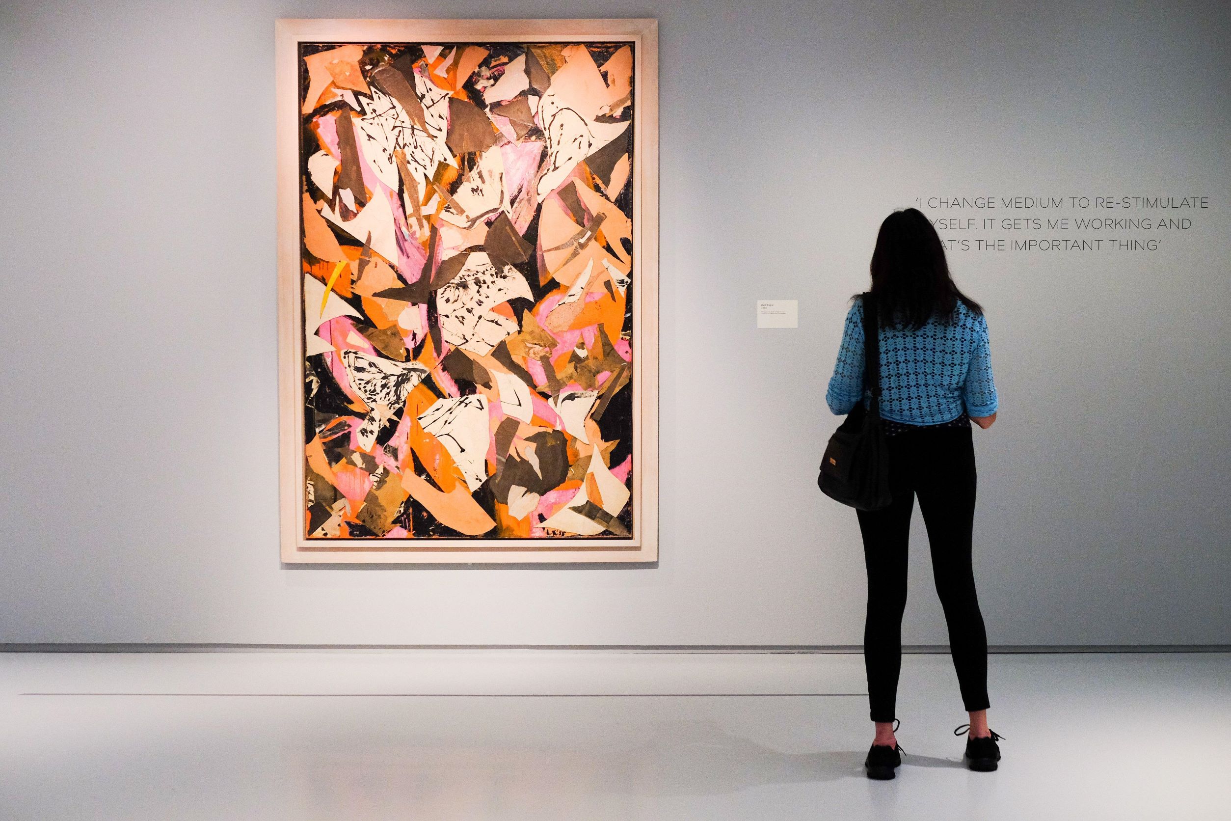 Image of woman examining Bald Eagle on display at the Lee Krasner: Living Colour exhibition in the Barbican Centre in London. Katie Collins / Alamy Stock Photo