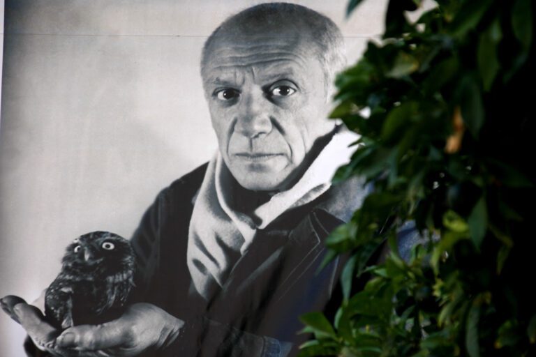 Black and white poster with Pablo Picasso, whose paintings are listed on the artwork pricing database of art investment platform Masterworks, portrait and green tree at Picasso exhibition hall, Dubrovnik, Croatia. Photo From Shutterstock