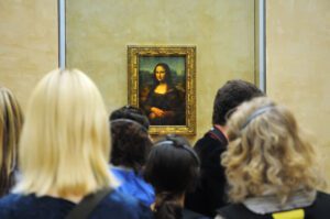 Tourists and the Mona Lisa in the Louvre Museum, Paris