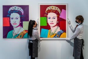 Art handlers with Pop Art paintings before art sale 